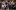 A group of people pointing in different directions