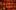 The inside galleries of the Globe Theatre are bathed in a red light.