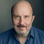 Paul Chahidi looking directly at the camera.