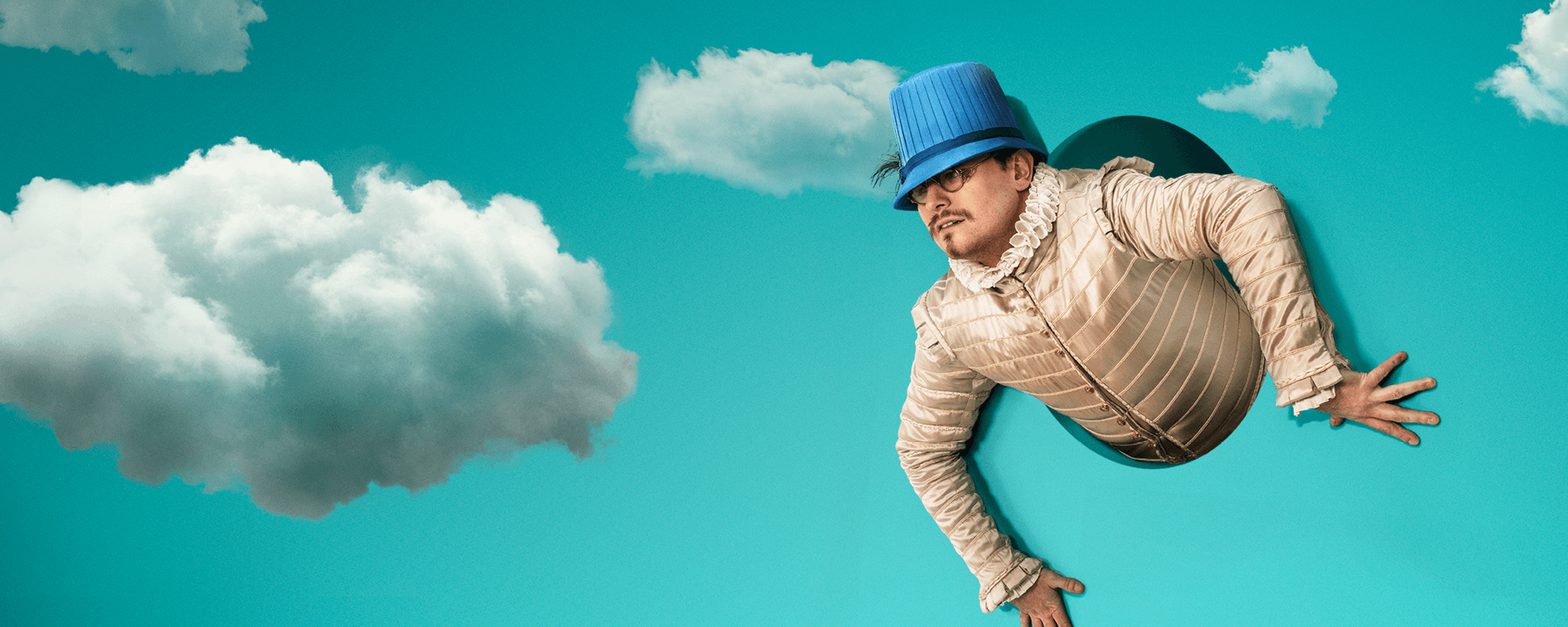 The torso of a man in Elizabethan dress appears from a hole in a blue backdrop with clouds.