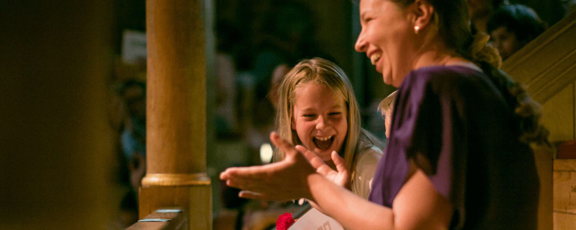 A parent and child laughing