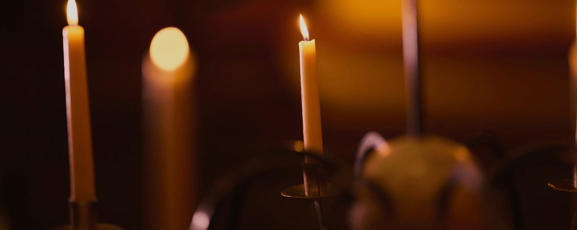 A close up shot of a candelabra with lit candles