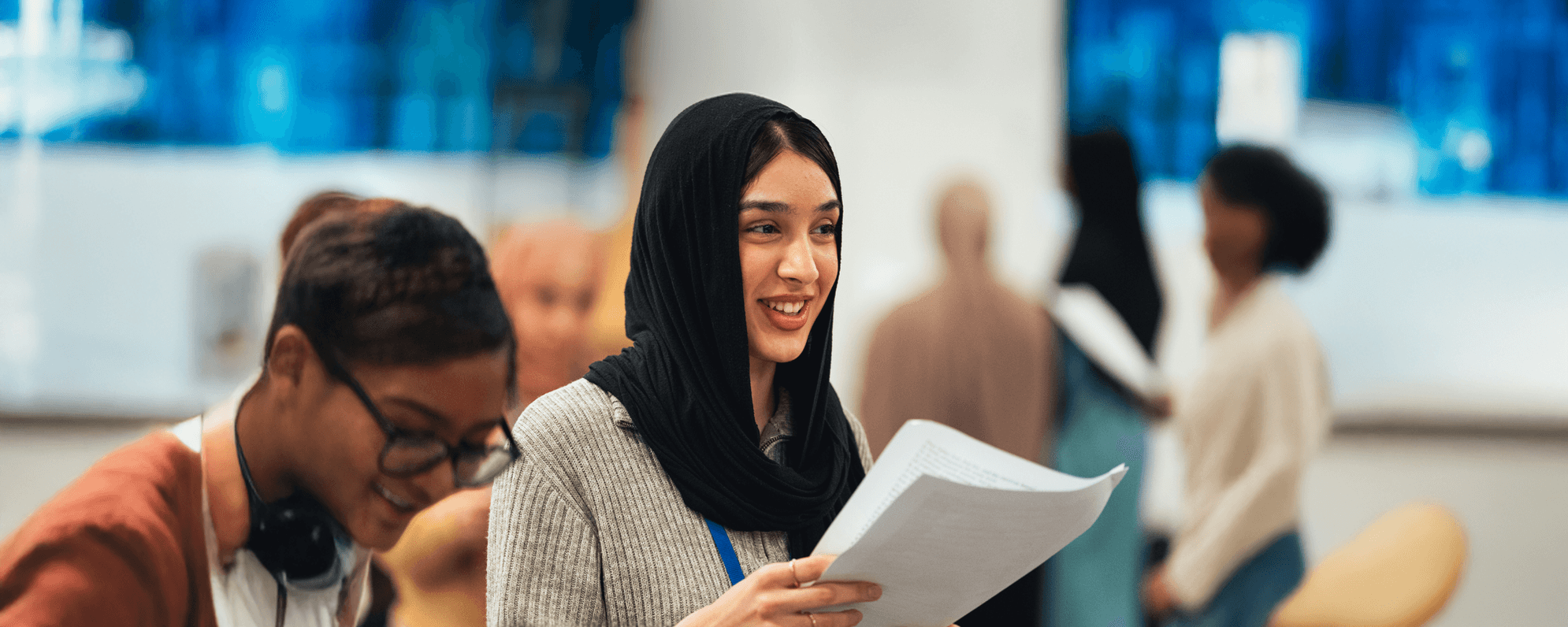 Young people in a rehearsal room with scripts