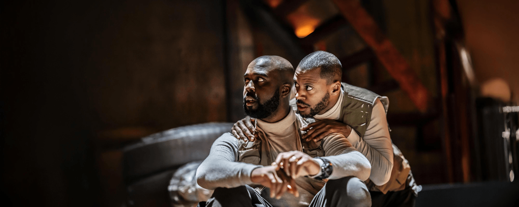 Two actors in 'Othello', onstage looking intrigued