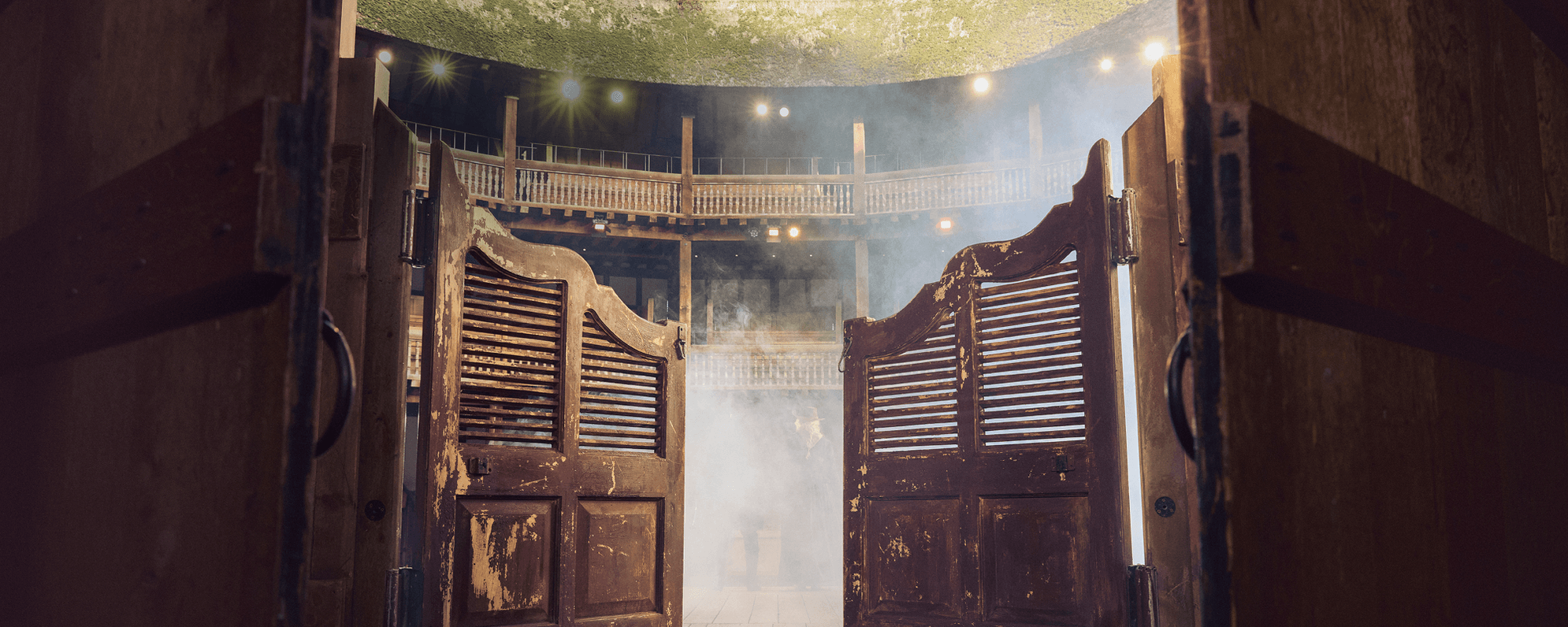 Saloon doors opening into a misty interior at the Globe