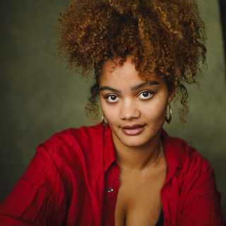 Inez Solomon wearing a red shirt and looking directly at the camera.