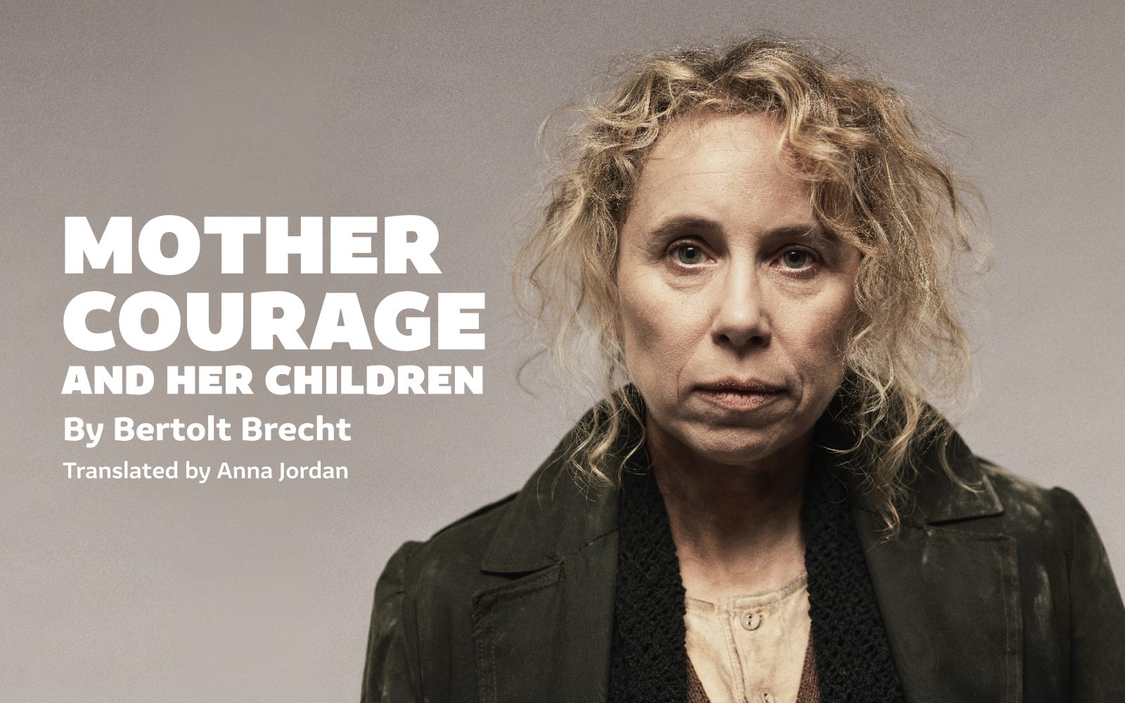 Mother Courage and Her Children by Bertolt Brecht, translated by Anna Jordan. Michelle Terry, a white woman with long curly hair, wears a dark overcoat.