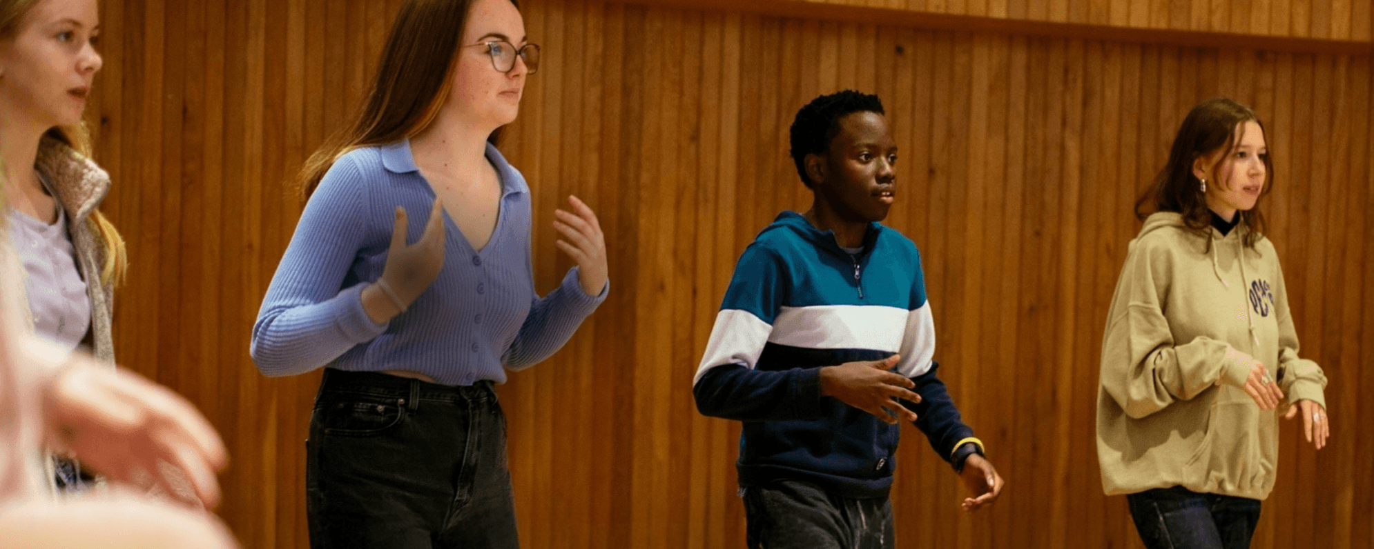 Four young people taking part in a young actors workshop.