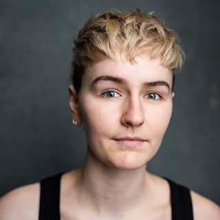 Headshot of Em Prendergast looking directly at the camera.