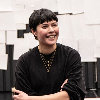 Nina Segal with arms folded, smiling