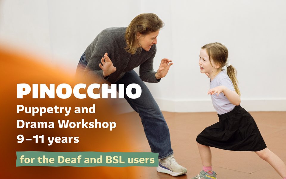 A parent crouched down and facing a child as they take part in a workshop. Pinocchio: Puppetry and Drama Workshop for the Deaf and BSL users (9-11 years).