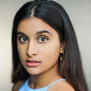 Headshot of Tanvi Virmani looking directly at the camera, wearing a light blue top.