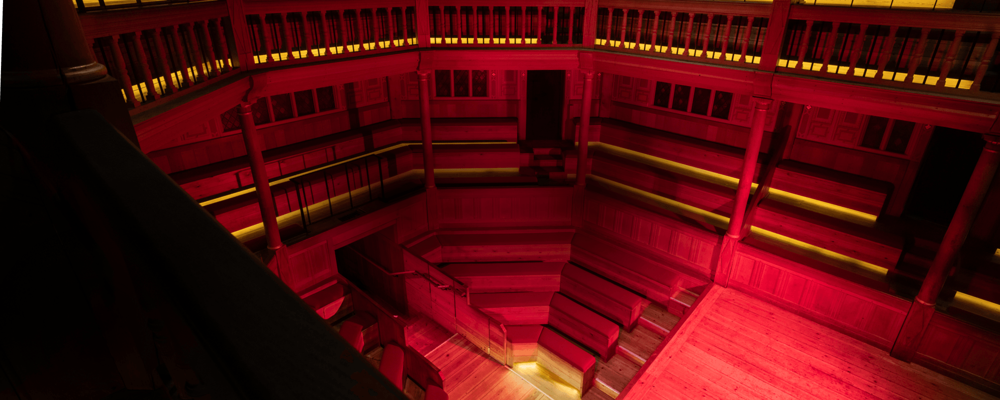 The interior of a wooden playhouse bathed in a red light.
