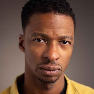 Simon Manyonda looking directly at the camera.